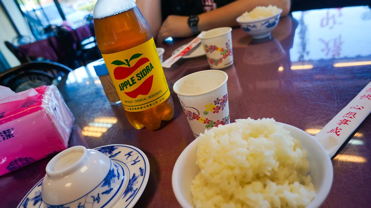 Apple Sidra and a bowl of rice. A 2013 domestic dining-table scene showing the national beverage’s cultural place in everyday eating.