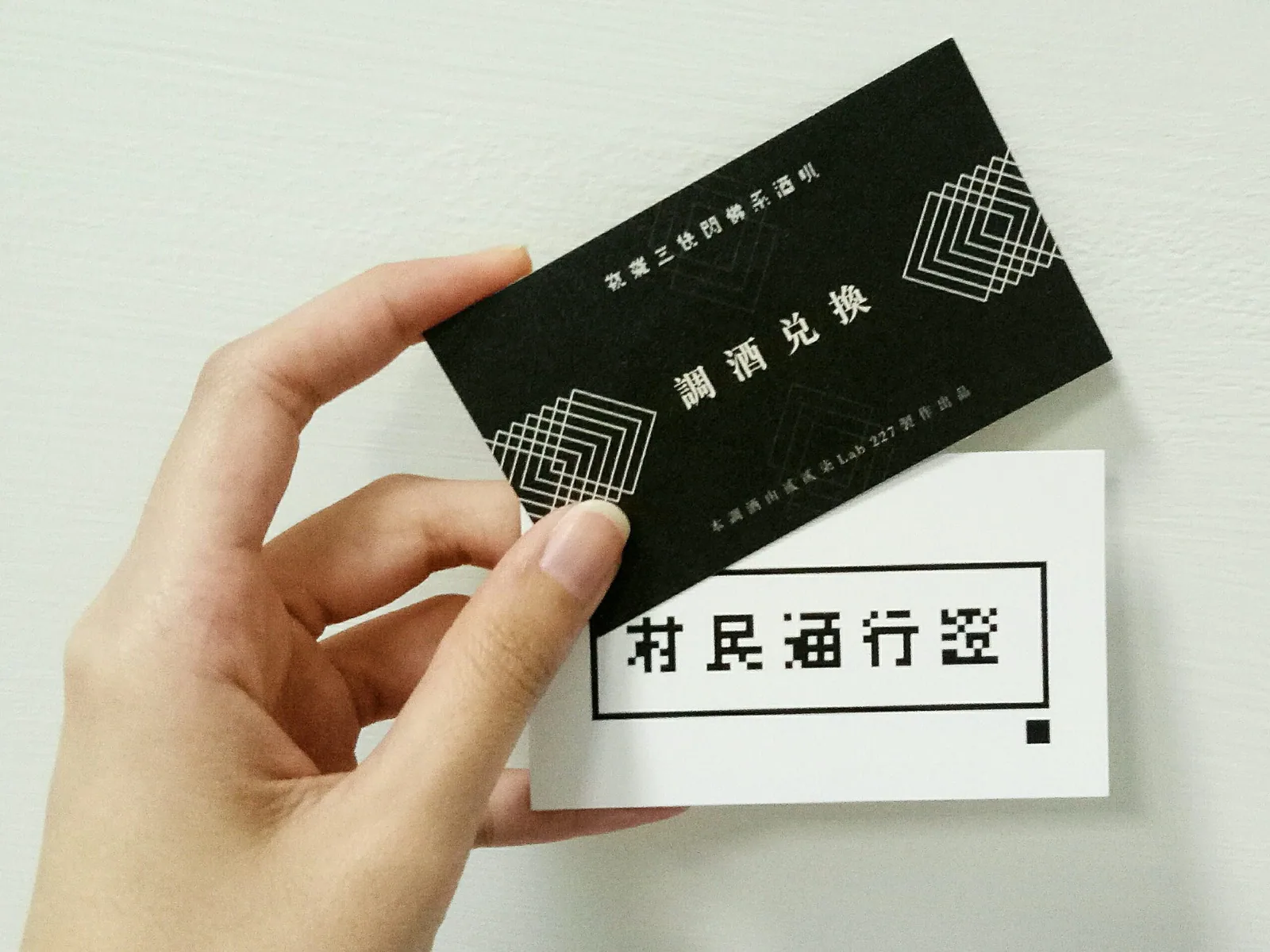A hand holding two coupons, one printed with 
